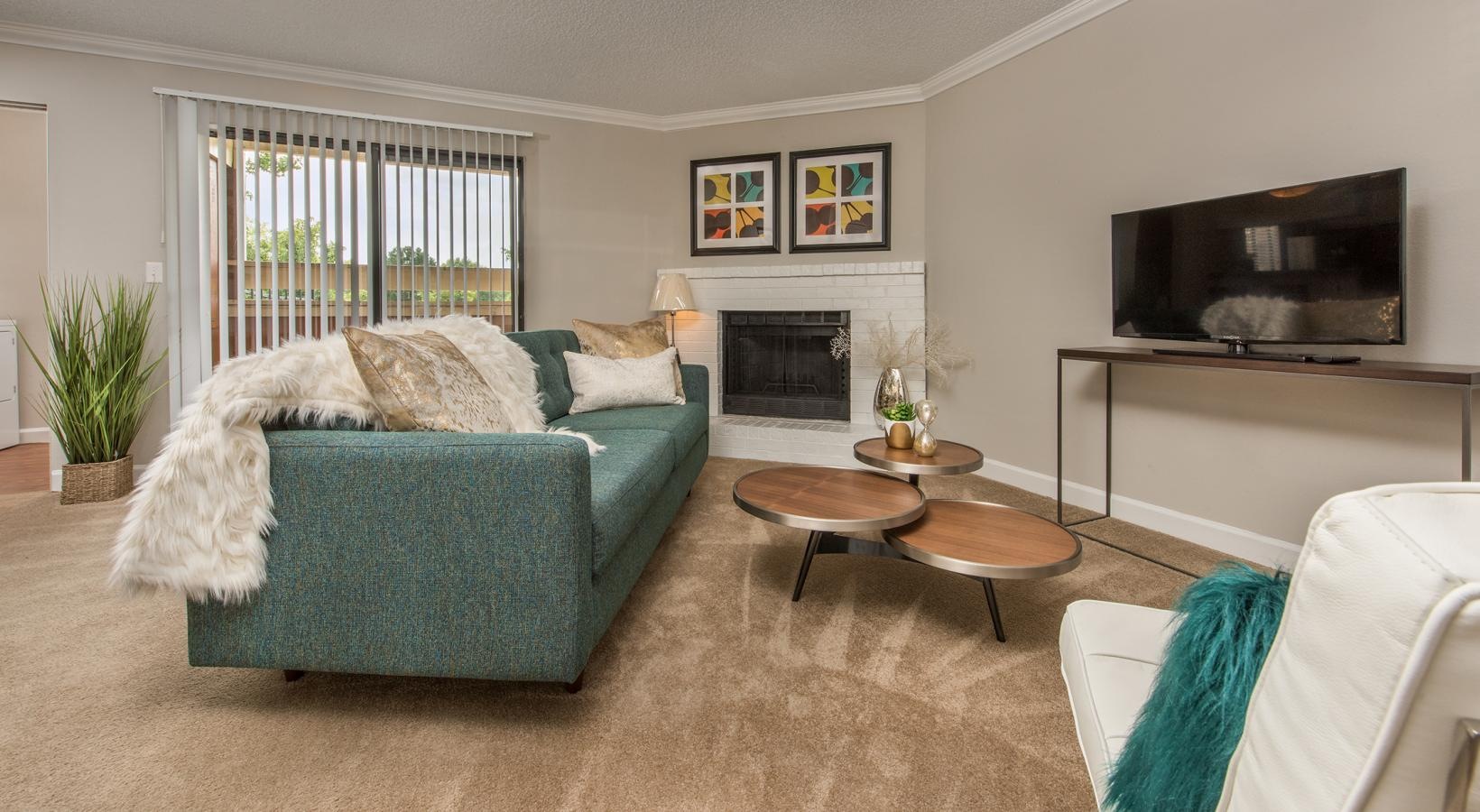 Gorgeous living areas to entertain and enjoy a living room with a fireplace a couch and a coffeetable