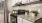 a kitchen with white cabinets a stovetop and a window