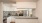 a kitchen with white cabinets and a breakfast bar
