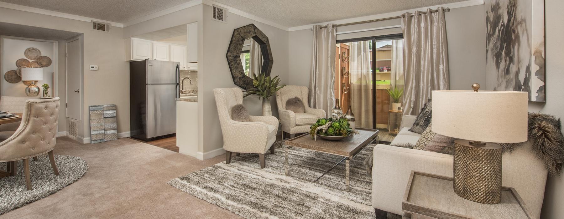 a living room with a rug and a couch a table