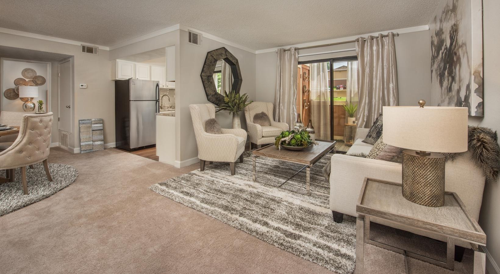 Wide open living areas perfect for entertaining a living room with a rug and a couch a table