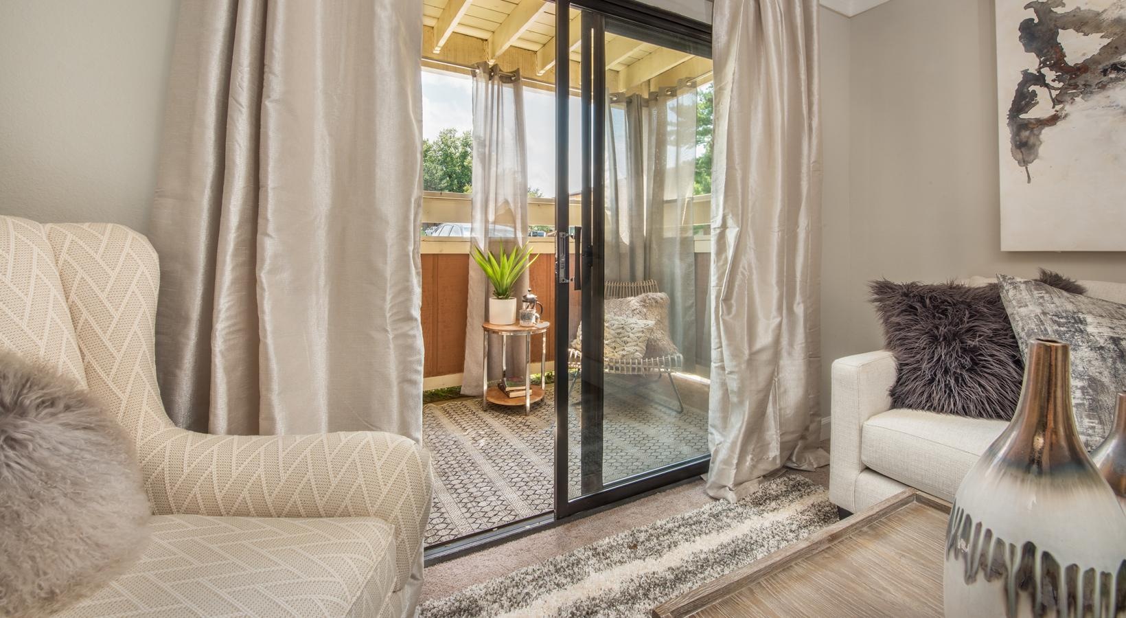 Relax and unwind in stylish living spaces a living room with a glass balcony door
