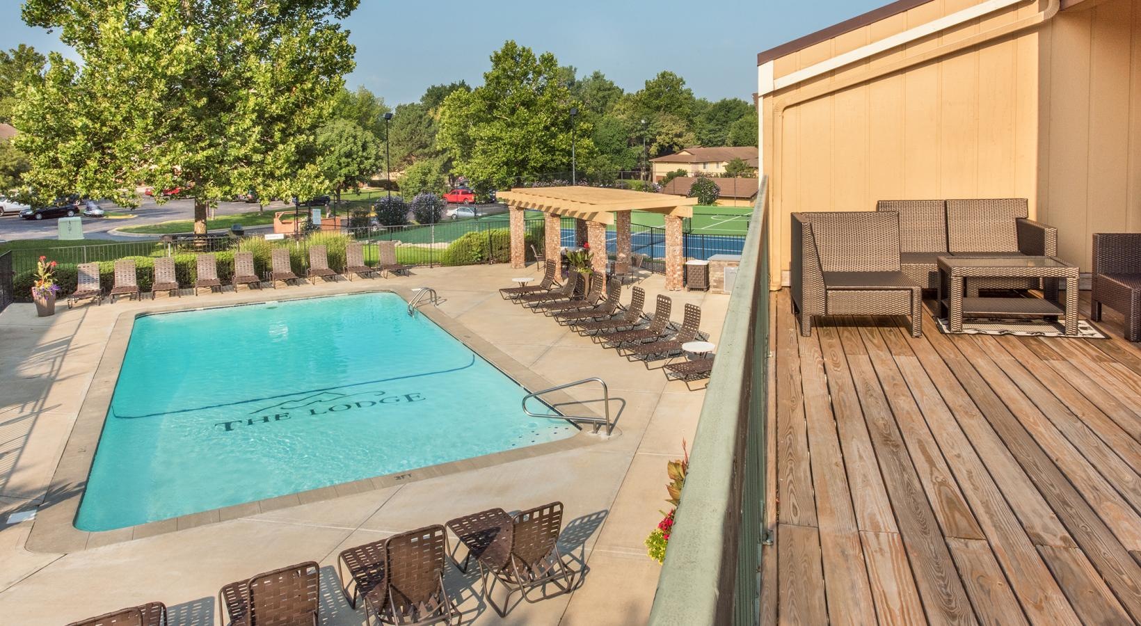 Relax and unwind poolside a swimming pool and a deck