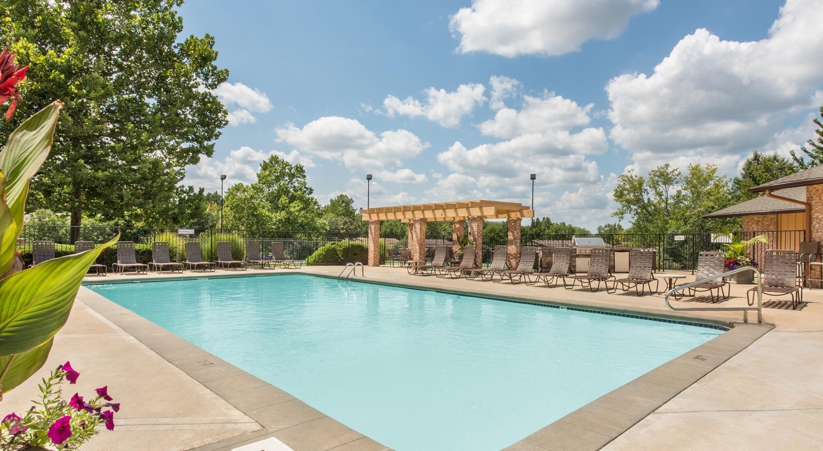 Sparkling swimming pool a pool with a building in the background