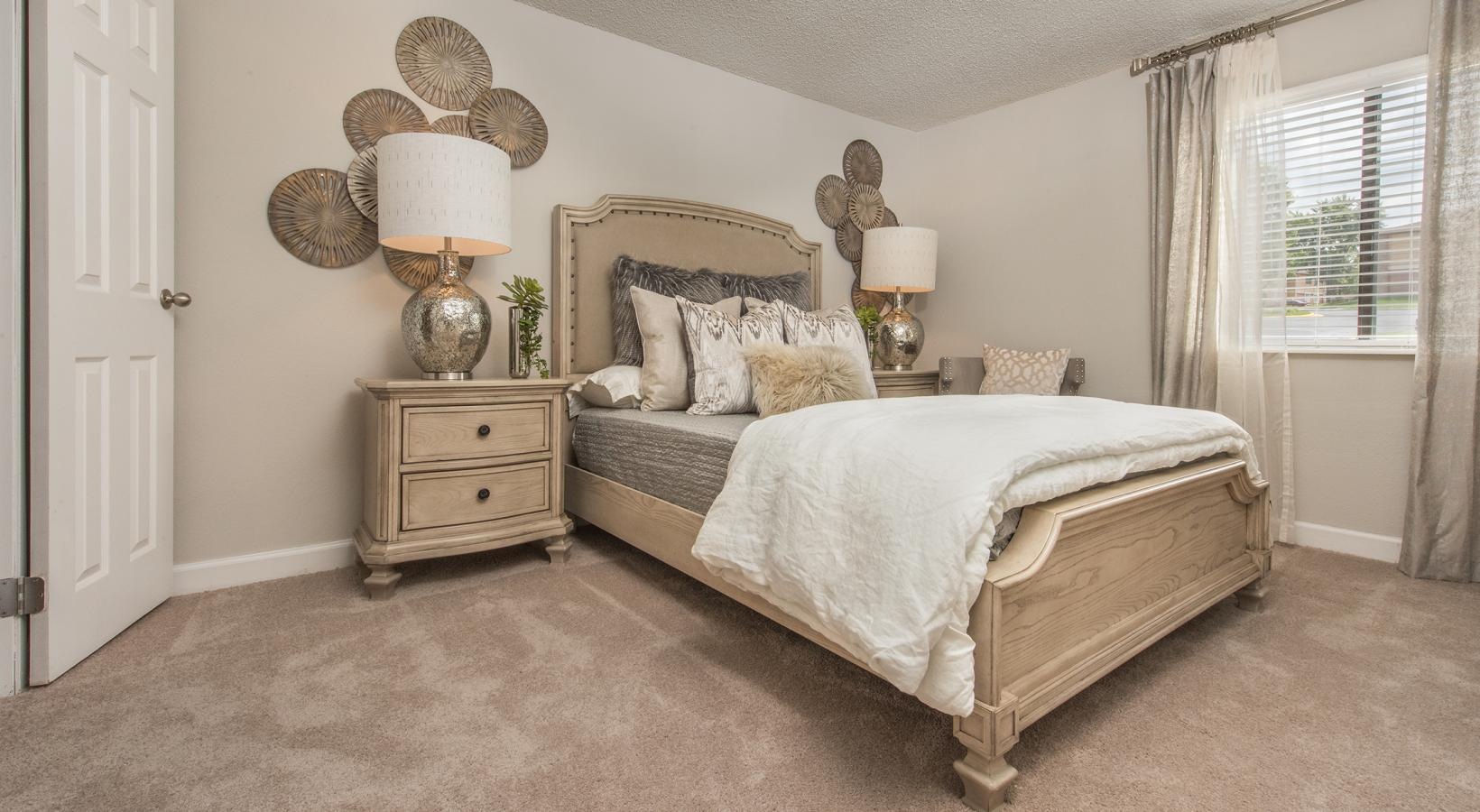 Sleep in style a bedroom with a bed and lamps and a window