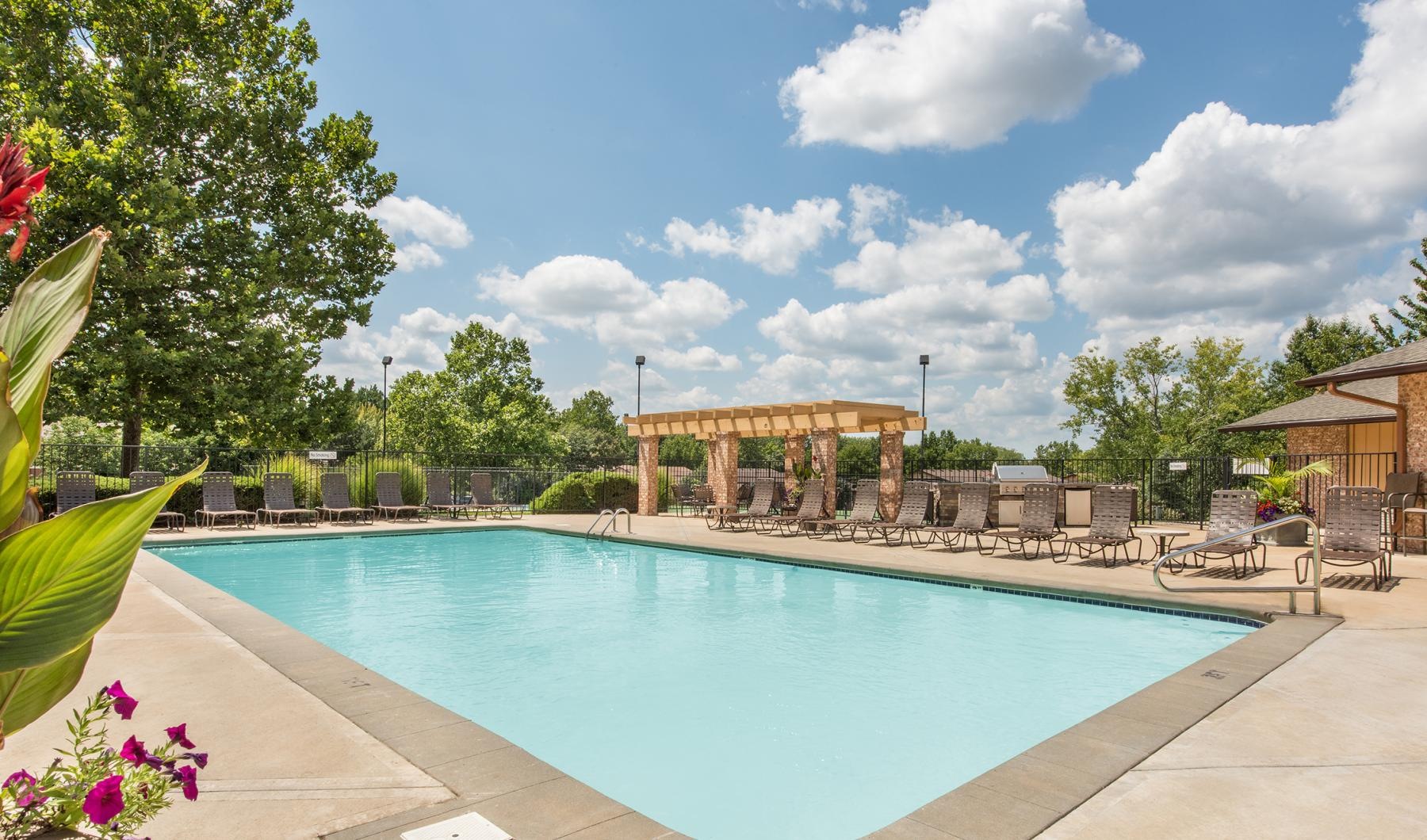 Sparkling swimming pool a pool with a building in the background