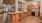 a communal kitchen with a bar and stools
